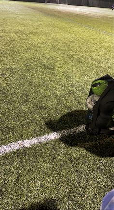 a backpack sitting on top of a soccer field