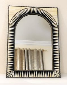 a mirror sitting on top of a white shelf