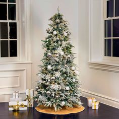 a decorated christmas tree with white and silver decorations