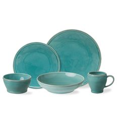 a set of blue dishes with cups and saucers on the side, in front of a white background