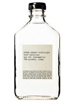 a glass bottle with a label on the top that says kings county distillary