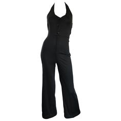 Sexy vintage 70s black jersey halter jumpsuit! Features a tailored bodice that buttons up the front. Hidden zipper at waistband. Nice flare legged / bell bottom. Buttons at back center halterneck. Looks amazing on, and hugs the body in all the right places. Can easily be dressed up or down. Great with sandals, wedges, flats or heels. In great condition. Made in USA. Approximately Size Small / Small Medium Measurements: (lots of stretch) 30-34 inch bust 24-30 inch waist 34-40 inch hips 58 inches Bell Bottom 70s, Halston Vintage, Veil Updo, 70s Jumpsuit, Bell Bottom Jumpsuits, Disco Jumpsuit, Suits Outfits, Vintage Disco, Fashion 1970s