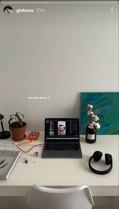 a laptop computer sitting on top of a white desk