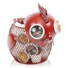 a red teapot filled with assorted coffee beans in it's netted container