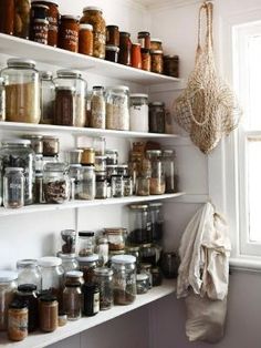 the shelves are filled with many different types of jars and containers, including one for spices