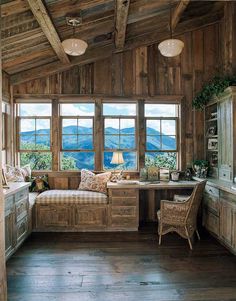 a living room filled with furniture and wooden walls