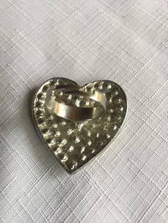 "Pave clear rhinestone heart shaped ring, very 70s. The heart is about 1.625 wide and tall. Classic cocktail ring, retro elegant. Size 8.5, but it's adjustable so it would fit to about size 10.5 comfortably. Could also be used as a scarf ring. Please know that if you don't like the way the ring fits, you can return it; you pay for the shipping, but there's no restocking fee or questions asked, I just refund the ring's cost. Also, please take a look at my storefront at: https://www.etsy.com/shop/ Silver Heart Shaped Metal Ring, Silver Heart-shaped Metal Ring, Metal Heart Ring As Gift, Vintage Metal Crystal Promise Ring, Vintage Open Heart Ring For Promise, Heart-shaped Metal Ring Gift, Vintage Open Heart Promise Ring, Metal Heart Ring For Valentine's Day, Metal Rings For Anniversary On Valentine's Day