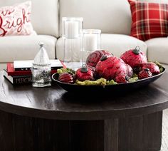 a tray with red ornaments on top of a coffee table