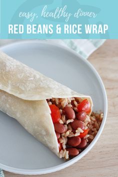 a burrito filled with beans and rice on a plate