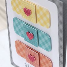 three different colored paper hearts are in a card box with the words cut it out