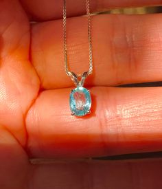 "Beautiful, dainty/minimalist, but will definitely not gone unnoticed, natural, paraiba, and paraiba color: known for its bright neon colours. The colour ranges from blue to green. Stone size: 7*5mm, 0.90 carats, set in 925 sterling silver, with 18\" inches long sterling silver box chain." Light Blue Aquamarine Birthstone Jewelry, Light Blue Sapphire Jewelry Gift, Light Blue Sapphire Jewelry For Gift, Aquamarine Round Pendant Gemstone Jewelry, Aquamarine Birthstone Pendant Jewelry, Blue Topaz Minimalist Jewelry, Elegant Apatite Jewelry With Birthstone, Elegant Apatite Birthstone Jewelry, Everyday Blue Topaz Jewelry