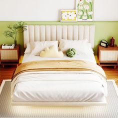 a bedroom with green walls, white bedding and two nightstands on either side