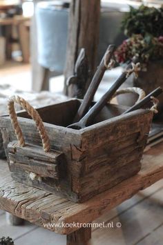 an old wooden crate filled with tools on top of a table