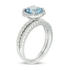 For your modern bride-to-be, this confident bridal set celebrates your exciting romance. Crafted in sterling silver, the dazzling engagement ring features an 8.0mm lab-created icy-blue aquamarine wrapped in a frame of shimmering white topaz. Additional topaz glisten along the shank. On your wedding day, complete her look with the coordinating topaz-lined band. Polished to a bright shine, this bridal set is made to sparkle as long as your forever love. Custom-made to fit her ring size. Sterling s Formal Bridal Sets With Round Cut Accent Stones, Round Bridal Sets With Halo Setting For Anniversary, Halo Design Bridal Sets For Wedding, Cubic Zirconia Bridal Sets With Round Band For Wedding, Cubic Zirconia Halo Ring With Accent Stones For Wedding, Cubic Zirconia Bridal Sets With Round Band, Fine Jewelry Bridal Set With Round Band For Wedding, Diamond Bridal Sets With Accent Stones For Wedding, Wedding Bridal Sets With Center Stone, Round Cut