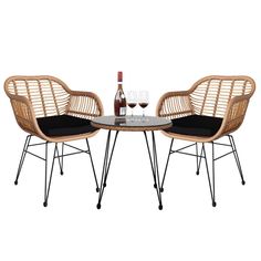 two wicker chairs and a table with wine glasses on it, against a white background