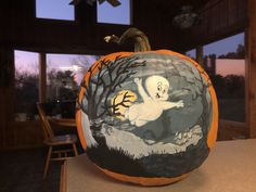 a painted pumpkin with a ghost on it