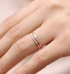 a woman's hand with a diamond ring on top of her left hand,