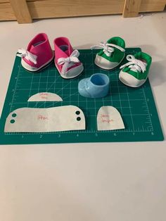 three pairs of shoes are sitting on a cutting board next to a pair of scissors