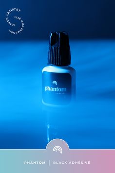 Bottle of Phantom black eyelash adhesive in a cloud of smoke.