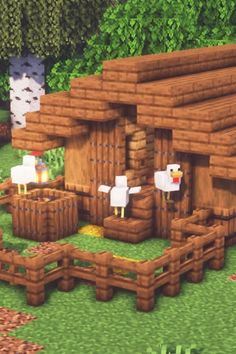 the farm is made out of wood and has sheep standing outside in front of it