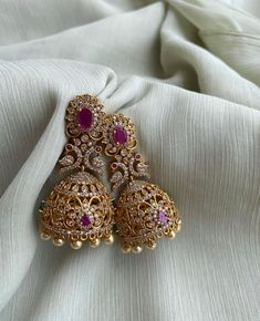 TEMPLE JHUMKA Kemp Ruby Stones Jhumka Earrings/Light weight /Antique Gold Finish/Indian Jewelry/desi jewelry / indian jhumkas Size : 3 inches approx  light weight  Elevate your style with these exquisite Temple Jhumka Earrings adorned with vibrant Kemp Ruby Stones and finished in antique gold. These Indian-inspired jhumkas are designed for both elegance and comfort, measuring approximately 3 inches in length and crafted to be delightfully lightweight. Embrace the timeless charm of desi jewelry with these stunning Indian jhumkas. Luxury Kundan Jhumkas In Temple Jewelry Style, Luxury Elegant Jhumkas For Reception, Luxury Bollywood Jhumkas With Stone Work, Luxury Earrings For Eid Celebrations, Luxury Chandbali Jhumkas For Diwali, Luxury Intricate Design Jhumkas, Luxury Traditional Jhumkas With Intricate Design, Luxury Traditional Jhumkas For Wedding, Luxury Kundan Temple Jhumkas