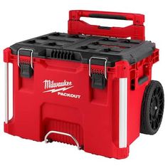 a red and white milwaukee tool box with wheels on it's side, showing the lid