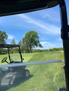 a golf cart is parked in the grass