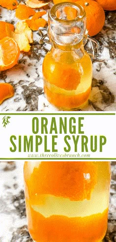 orange simple syrup in a glass jar on a marble counter top with sliced oranges around it