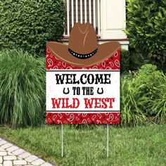 a welcome to the wild west sign with a cowboy hat on it