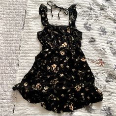 Cute Black Ruffled Sundress With Yellow Flowers, Ties High In The Back. Size Small, There’s Ruffles Along The Bottom Of The Dress With More Ruffles On The Straps Going Down The Bust. Pretty Design! Never Worn, Nwot. Black Ruffled Sundress For Spring, Fitted Black Sundress With Ruffles, Black Ruffled Mini Sundress, Black Mini Sundress With Ruffles, Black Beach Dress With Ruffled Straps, Black Dress With Ruffled Straps For Beach, Black Vacation Dress With Ruffled Straps, Black Sundress With Ruffles, Black Ruffled Sundress