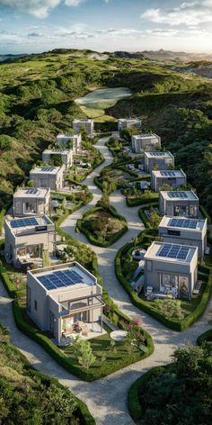 an aerial view of houses with solar panels on the roof and green grass around them