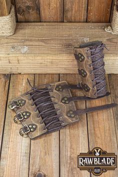 an old pair of boots sitting on top of a wooden bench