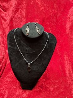 If tou are looking for a beautiful lightweight jewelry set look no farther. This gorgeous Coffin Cross Necklace and Earring Set is a perfect gift for anyone !  The necklace is 18 inches and has a beautiful alloy Coffin Charm with beads adorning each one . Comes in Crimson Red or Black ! Gothic Teardrop Silver Jewelry, Gothic Silver Teardrop Jewelry, Costume Jewelry Sets With Matching Earrings For Gifts, Cadmium-free Black Jewelry For Gift, Cadmium-free Black Jewelry Gift, Nickel-free Metal Jewelry For Gifts, Nickel-free Metal Jewelry As Gift, Stainless Steel Dangle Jewelry For Gifts, Adjustable Metal Jewelry Sets As Gifts