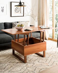 a living room with a couch, table and chairs next to a large open window