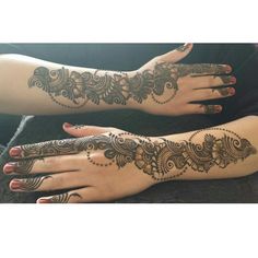 two hands with henna tattoos on them