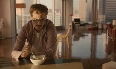 a man sitting at a table in front of a bowl