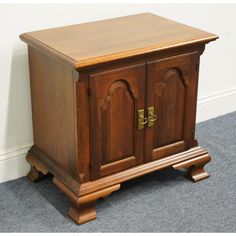 a wooden cabinet with two doors on the front