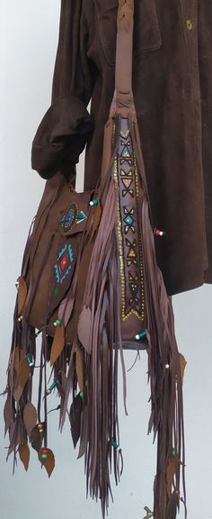 Native American inspired Handmade Leather Fringed Crossbody Bag.. Dark vintage brown Leather. Crossbody or Shoulder Bag depend your mood !! Beautiful Ethnic Handbag with Fringes and Beads. Painted with Native American Symbols-Desings- embroidered with nice colors! Both side of the Bag are Fringed and decoraded with beads-(you can ad your personal charms if you want). I enjoy every moment creating this exceptional Bag. Become better with hard use.Will take beautiful shades when aging. I wish that Hippy Party, Western Bags, Leather Fringe Handbag, Boho Chic Bags, Western Bag, Crossbody Leather Bag, Leather Fringe Bag, Western Handbags, Native American Symbols