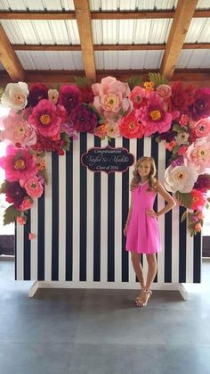 a woman standing in front of a flower display