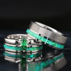 two wedding rings with green opal inlays