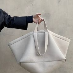 The light weight mesh A E K I Bag is a Jasmin Shokrian classic. The Large A E K I Bag was originally developed in 2015 as a part of the Jasmin Shokrian SS 2105 collection. Based on a Utilitarian classic this oversized, Lightweight durable bag is great as a day time accessory, and is perfect as a both a carry all and a carry on.Currently available in a classic JS ATELIER palette of NUDE, MIDNIGHT and BLACK. As well as TENNIS, WEED GREEN, COYOTE and THIRST. Please note that this Item is currently Handheld Bucket Bag With Dust Bag, Modern Canvas Bag With Large Capacity And Top Handle, Accessories Inspiration, Day Time, Unique Bags, Day And Time, Carry On, Bag Accessories, Tennis