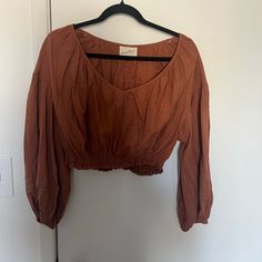 Universal Thread Cropped Blouse Size Large. Color Is A Burnt Orange. Never Worn. Chic Brown Tops For Daywear, Brown Cotton V-neck Blouse, Brown Relaxed Fit Top For Daywear, Brown Relaxed Fit Blouse For Day Out, Brown Spring Tops For Daywear, Bohemian Brown Crop Top, Brown Tops For Spring Daywear, Brown Tops For Daywear In Spring, Brown Cotton Blouse For Spring