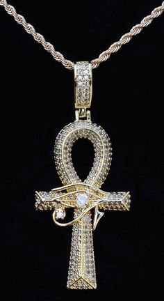 Exquisite Egyptian Large CZ Ankh with Eye of Horus overlay and many micro-pave cubic zirconium stones inlaid in Gold filled Ankh including a larger CZ stone as the Eye of Horus--simply STUNNING! ONLY {1} AVAILABLE! Large Ankh Charm | Eye of Horus  is gold filled with a hollow back ❤ A Powerful and Ancient Gift      for the One you Love  ❤ Gift for Him or for Her ❤ Rope Chain is made of       stainless steel with gold plating     = 2mm wide  CHOOSE YOUR CHAIN LENGTH FROM OUR PULL-DOWN MENU:  ❤    45 cm / 17.7 inches long      w/ lobster clasp. Will NOT tarnish OR  ❤    50 cm / 19.7 inches long      w/ lobster clasp. Will NOT tarnish OR  ❤    55 cm / 21.6 inches long      w/ lobster clasp. Will NOT tarnish OR  ❤    60 cm / 23.6  inches long      w/ lobster clasp. Will NOT tarnish ❤ Ankh Char Ankh Wallpaper, Ankh Jewelry, Ankh Jewelry Necklaces, Egyptian Jewelry Ancient, Luxury Symbolic Ankh Necklaces, Luxury Gold Ankh Necklace, Luxury Symbolic Ankh Necklace, Gold Ankh Amulet Jewelry, Egyptian Ankh Necklace