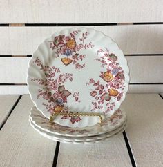 three plates stacked on top of each other in front of a white wooden tablecloth