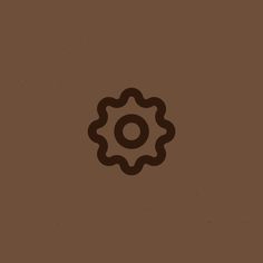 a brown background with a black and white image of a cogwheel on it