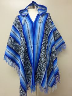 "BLUE AND BLACK HOODED SHAMAN AGUAYO PONCHO This poncho is handwoven in the traditional Andean method \"Aguayo\" This poncho will fit people size ranging from medium to large. AGUAYO: It is a naturally dyed blend of alpaca, llama, and sheep wool; handwoven in the Andean village of Peru called Paucartambo by the Q'eros community. Country: Perú Culture: Quechua Material: Alpacryl ( Alpaca and acrylic) Measurement: 70 X 46 ( including fringe)" Traditional Blue One-size Poncho, Traditional Blue Poncho, Traditional One Size Hooded Poncho, Blue Winter Festival Poncho, One Size Blue Poncho For Festivals, Blue One-size Poncho For Festivals, Blue One Size Poncho For Festival, Peru Culture, Fit People