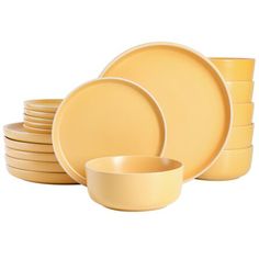 a stack of yellow dinnerware on a white background