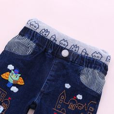 These brightly coloured , elasticated waist jeans are a must have in your little boy's wardrobe. Heavily embroidered and appliqued with fun characters these are sure to brighten any day. Perfect for a day out and about. Team the trousers with a shirt, T shirt, cardigan or sweater from our range. Pattern Type: Embroidered/ Appliqued Characters Material: Cotton Fit: Fits true to size, take your normal size Age Range:12 Months-6 Years Cute Cotton Bottoms With Cartoon Print, Fun Blue Cotton Jeans, Playful Blue Pants With Pockets, Cute Cotton Straight Leg Bottoms, Cute Straight Leg Cotton Bottoms, Playful Cotton Jeans For Spring, Cute Blue Cotton Pants, Playful Spring Cotton Jeans, Playful Denim Blue Bottoms