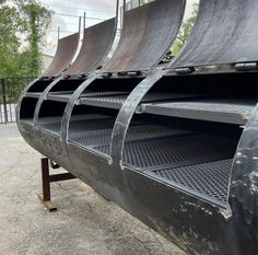 the back end of a large truck with its doors open and some metal bars attached to it