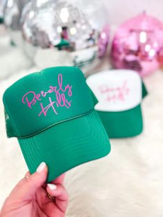 Top off your look with this stylish, Beverly Hills-approved trucker hat! The bright green color features a bright splash of pink lettering - guaranteed to turn heads. Perfect for a day outdoors, this hat is the ultimate accessory for a mood to match the sunny weather!